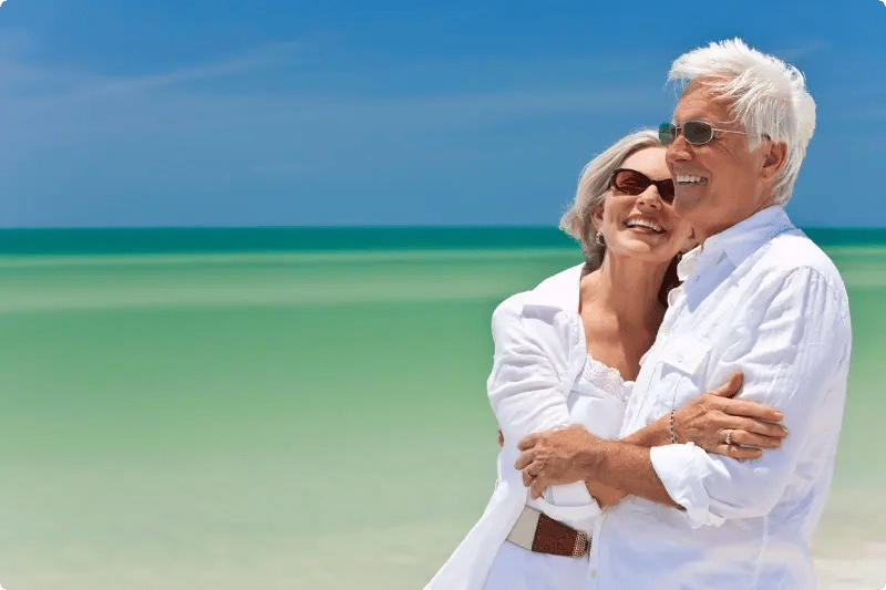 Ouder stel lachend op een strand